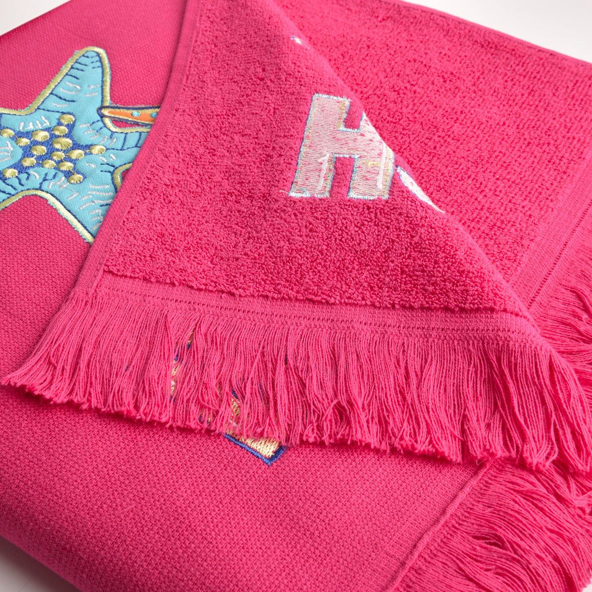 Telo mare Vingi spugna "Beach" fuxia con frange 100% cotone